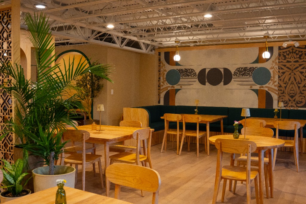 Dining tables and a banquette in the Cube Coffee event space