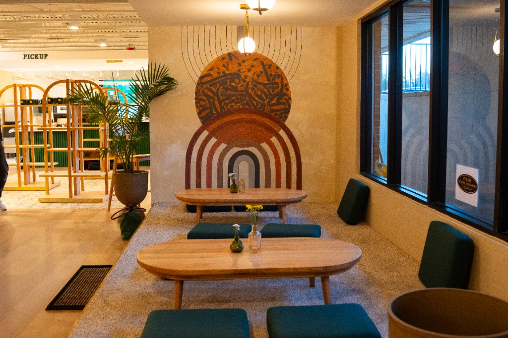 Window nook with floor cushions and low wood tables