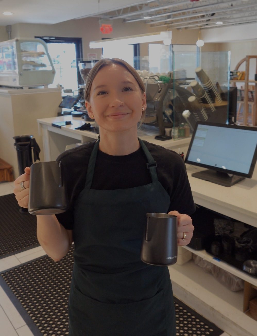 Barista at Cube Coffee preparing a drink